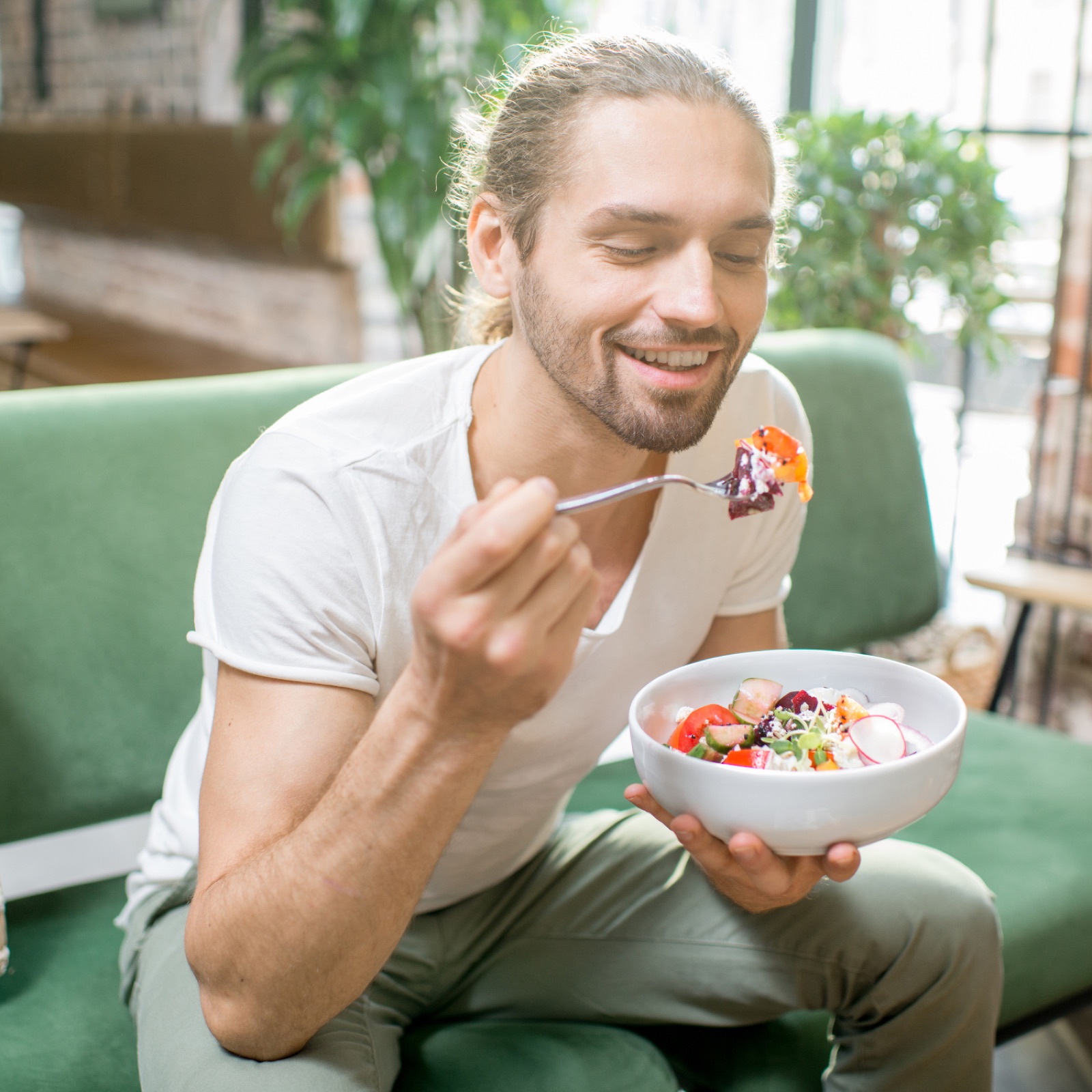 A person eating a meal slowly and mindfully at a table, building a healthy relationship with food